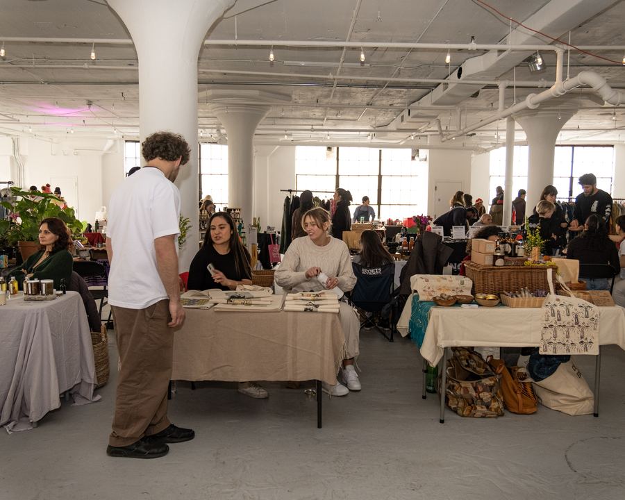 Shoppers and artisan vendors filling a bright loft space at a Mindful Matter Market