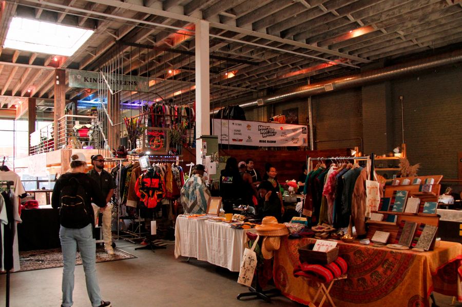 Vintage clothing, artwork and homeware stalls inside the warehouse space at a Mindful Matter Market