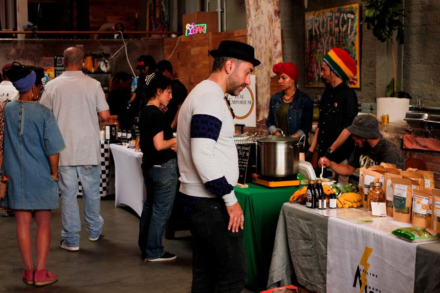 Plant based vendors serving guests from a stall at a Mindful Matter Market in New York
