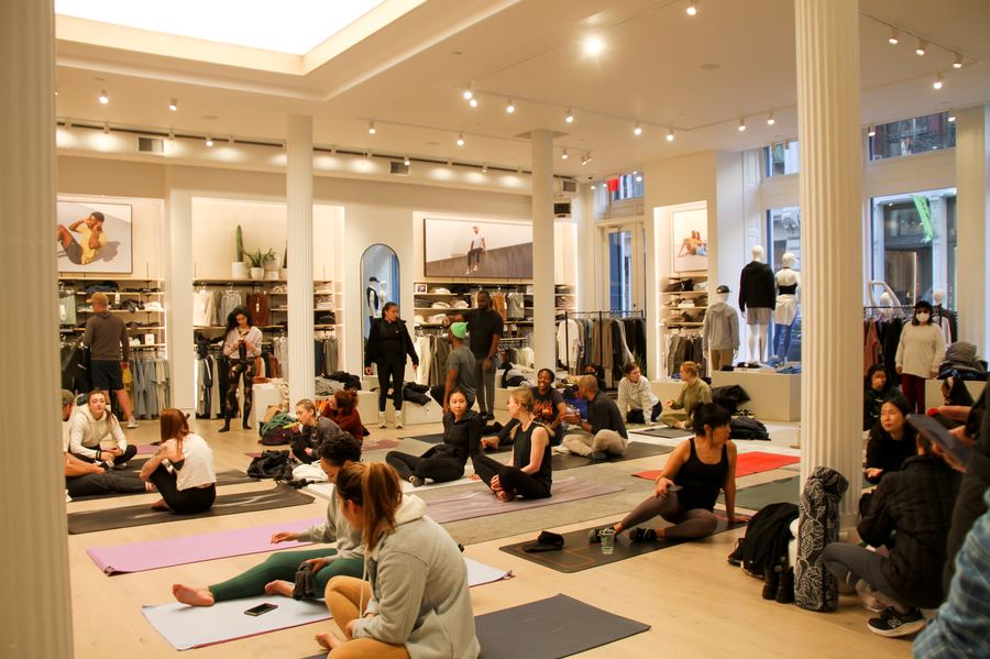 Participants seated on yoga mats before a Mindful Matter Market wellness class held in a SoHo retail space