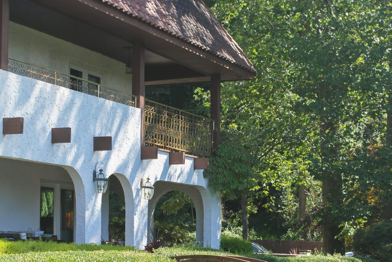 The terrace and gardens of the villa used for a Mindful Matter Market retreat, surrounded by woodland